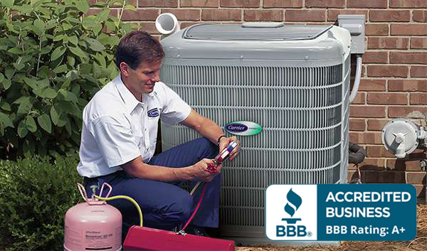 Repairman fixing Carrier AC unit Tampa AC Repair